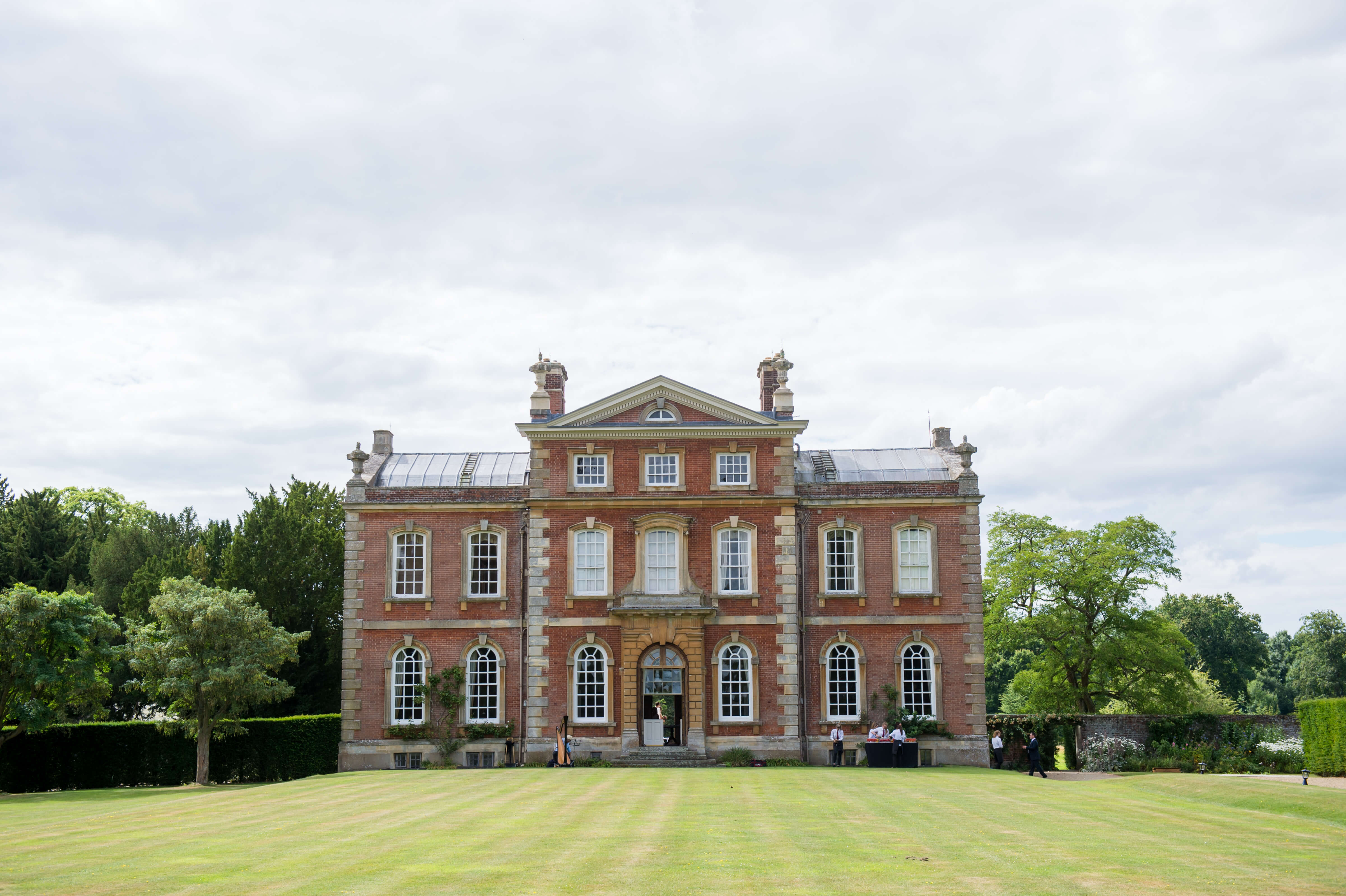Photograph of Kingston Bagpuize with the gardens in the foreground 